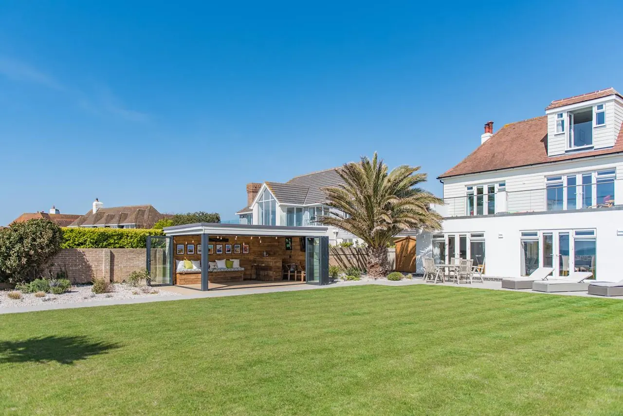 Sun Beach House from its lawn, with the sea behind